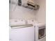 The laundry room features a modern washer and dryer with storage shelving above at 140 Clear Water Rd, Louisburg, NC 27549
