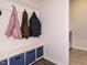 Welcoming mudroom features coat hooks and storage bench with view to laundry room at 140 Clear Water Rd, Louisburg, NC 27549