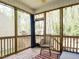 Relaxing screened-in porch with wooded views, string lights, and seating area at 140 Clear Water Rd, Louisburg, NC 27549