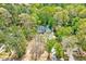 Aerial view of a light-blue two-story home surrounded by mature trees at 1433 Andersonwood Dr, Fuquay Varina, NC 27526