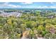 Scenic aerial view showcases the home's location amidst lush greenery and a sprawling neighborhood in the distance at 1433 Andersonwood Dr, Fuquay Varina, NC 27526