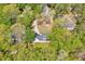 Expansive aerial view of a single-story home nestled among mature trees on a large, private lot at 1433 Andersonwood Dr, Fuquay Varina, NC 27526
