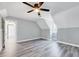 Open bedroom features a modern ceiling fan, two windows and luxury gray vinyl floors at 1433 Andersonwood Dr, Fuquay Varina, NC 27526