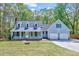 Charming two-story home with a well-manicured lawn and a welcoming two-car garage at 1433 Andersonwood Dr, Fuquay Varina, NC 27526