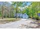Beautiful home with an inviting driveway, lush lawn, and mature trees in a serene setting at 1433 Andersonwood Dr, Fuquay Varina, NC 27526