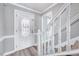 Bright foyer featuring a staircase with white railings and a decorative glass front door at 1433 Andersonwood Dr, Fuquay Varina, NC 27526
