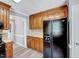 Kitchen featuring wood cabinets and sleek black appliances offering ample counter space at 1433 Andersonwood Dr, Fuquay Varina, NC 27526