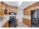 Kitchen featuring wood cabinets, a mosaic backsplash, and modern appliances at 1433 Andersonwood Dr, Fuquay Varina, NC 27526