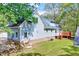 Rear of light-blue two-story home with brick foundation and deck at 1433 Andersonwood Dr, Fuquay Varina, NC 27526