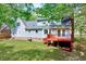 Back exterior of the home featuring a stained deck and lush lawn at 1433 Andersonwood Dr, Fuquay Varina, NC 27526