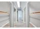A hallway of walk-in closets with bright lighting and built-in clothes racks at 1433 Andersonwood Dr, Fuquay Varina, NC 27526
