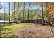 Large fenced backyard features mature trees, open space and storage shed at 1517 Laughridge Dr, Cary, NC 27511