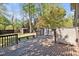 Backyard with wooden deck, mature trees, and privacy screens offer a relaxing outdoor space at 1517 Laughridge Dr, Cary, NC 27511