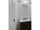 Small bathroom with a dark vanity, a white countertop sink, and a mirror at 1517 Laughridge Dr, Cary, NC 27511