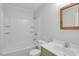 Well-lit bathroom with tub/shower combo, white tile, and updated vanity and sink at 1517 Laughridge Dr, Cary, NC 27511