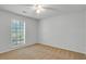 Comfortable bedroom with neutral carpet, ceiling fan, and bright window to let the light in at 1517 Laughridge Dr, Cary, NC 27511