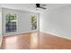 Sun-filled bedroom with hardwood flooring and large windows overlooking the landscape at 1517 Laughridge Dr, Cary, NC 27511