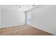 Bedroom includes neutral carpet, a ceiling fan, and natural light with large window at 1517 Laughridge Dr, Cary, NC 27511