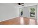 Bedroom with hardwood floors and windows overlooking green landscape at 1517 Laughridge Dr, Cary, NC 27511