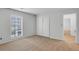 Bedroom boasts neutral walls, carpet flooring, large window, and access to ensuite bathroom at 1517 Laughridge Dr, Cary, NC 27511
