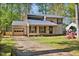 Charming two-story home with a neutral exterior, attached garage, and mature trees at 1517 Laughridge Dr, Cary, NC 27511
