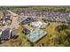 Aerial view of the community pool, tennis court, bocce ball court, and clubhouse at 158 Sea Foam Dr, Raleigh, NC 27610
