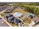An aerial view of the community pool, clubhouse, pond, and tennis courts at 158 Sea Foam Dr, Raleigh, NC 27610