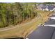 Aerial shot of a backyard with a stone fire pit and paved walking path at 158 Sea Foam Dr, Raleigh, NC 27610