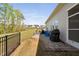 Charming backyard showcasing stone seating, grill, and direct access to the inviting screened-in porch at 158 Sea Foam Dr, Raleigh, NC 27610