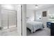 Clean, gray and white en-suite bathroom and view to bedroom with two windows at 158 Sea Foam Dr, Raleigh, NC 27610