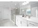 Modern bathroom with a glass door shower, white cabinets, and neutral tile flooring at 158 Sea Foam Dr, Raleigh, NC 27610