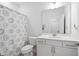 A bright bathroom with a decorative shower curtain and a modern vanity at 158 Sea Foam Dr, Raleigh, NC 27610