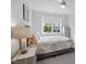 Bedroom with neutral tones and a large window providing natural light at 158 Sea Foam Dr, Raleigh, NC 27610