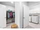 Dual closets, one featuring a doorway to the laundry room with modern appliances at 158 Sea Foam Dr, Raleigh, NC 27610