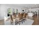 Dining room with wood table, chairs, and view of the backyard and kitchen at 158 Sea Foam Dr, Raleigh, NC 27610