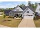 Charming home features a two-car garage, stone accents, covered porch and manicured landscaping at 158 Sea Foam Dr, Raleigh, NC 27610