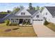 Charming home features a two-car garage, stone accents, covered porch and manicured landscaping at 158 Sea Foam Dr, Raleigh, NC 27610