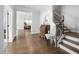 Bright foyer with hardwood floors, staircase, and elegant wooden secretary desk at 158 Sea Foam Dr, Raleigh, NC 27610