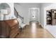 Spacious foyer with hardwood floors, stairs, and antique wooden furniture at 158 Sea Foam Dr, Raleigh, NC 27610