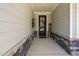 View of covered entry way and stylish front door framed by stone accents and a welcome sign at 158 Sea Foam Dr, Raleigh, NC 27610