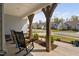 Inviting front porch with rocking chairs, wooden beams, manicured landscaping at 158 Sea Foam Dr, Raleigh, NC 27610
