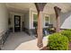 Inviting front porch with rocking chairs, wooden beams and stylish decor at 158 Sea Foam Dr, Raleigh, NC 27610