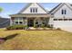 Charming home with a stone-accented porch, manicured landscaping, and inviting curb appeal at 158 Sea Foam Dr, Raleigh, NC 27610