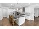 Kitchen with stainless appliances, a large island, and modern lighting fixtures at 158 Sea Foam Dr, Raleigh, NC 27610