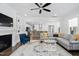 Open concept living room with fireplace, shelving, and view of the modern kitchen at 158 Sea Foam Dr, Raleigh, NC 27610