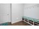 Bright mudroom with a cushioned bench, storage baskets, coat hooks, and access to a door at 158 Sea Foam Dr, Raleigh, NC 27610