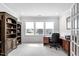 Bright office with ample natural light, custom built-in shelving, and neutral carpet at 158 Sea Foam Dr, Raleigh, NC 27610