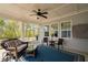 Beautiful screened-in porch with wicker furniture, ceiling fan, and relaxing views at 158 Sea Foam Dr, Raleigh, NC 27610