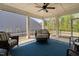 Screened-in porch with wicker furniture, ceiling fan, and serene views of the backyard at 158 Sea Foam Dr, Raleigh, NC 27610