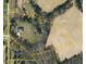 Expansive aerial view of a rural property with cultivated land and wooded areas in Browns Summit, NC at 1601 Dairyland Rd, Chapel Hill, NC 27516